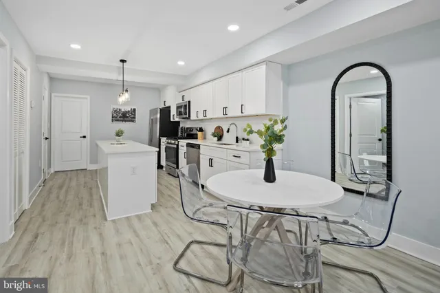 a dining room with furniture and wooden floor