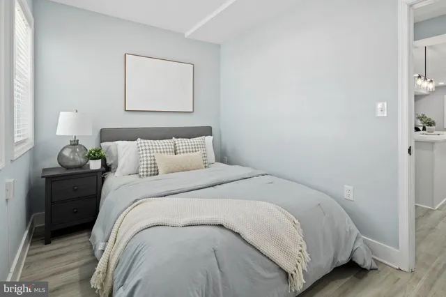 a bedroom with a bed and a painting