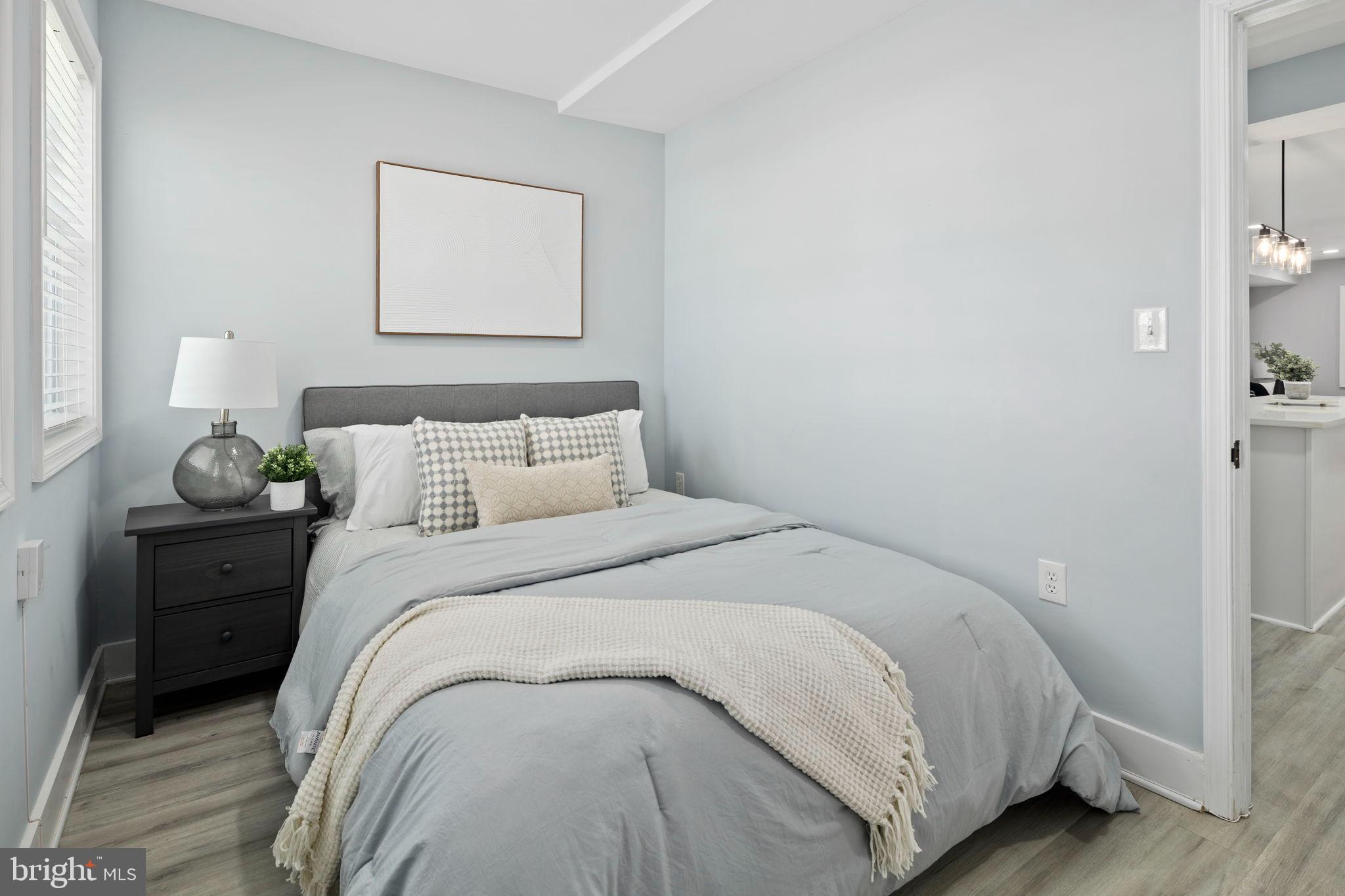 3418 Baker Street Northeast Washington, DC 20019 - Photo 15 of 46 a bedroom with a bed and a painting