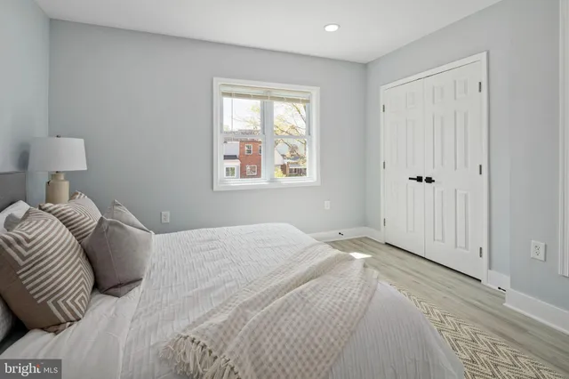 a bedroom with a bed and a window