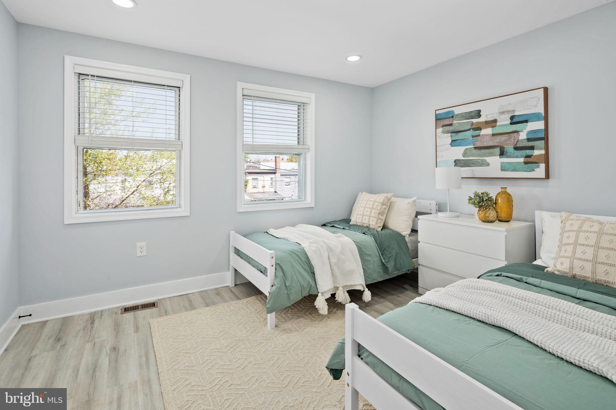3418 Baker Street Northeast Washington, DC 20019 - Photo 17 of 46 a bedroom with two beds and a window