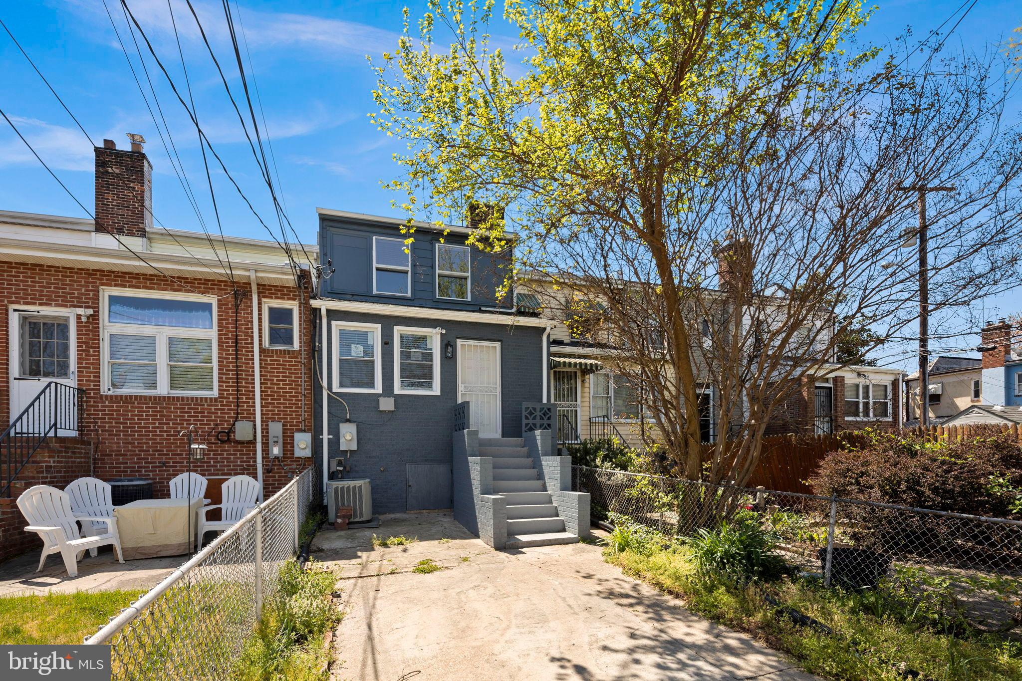 3418 Baker Street Northeast Washington, DC 20019 - Photo 18 of 46 a view of house with a yard outdoor seating and covered with trees