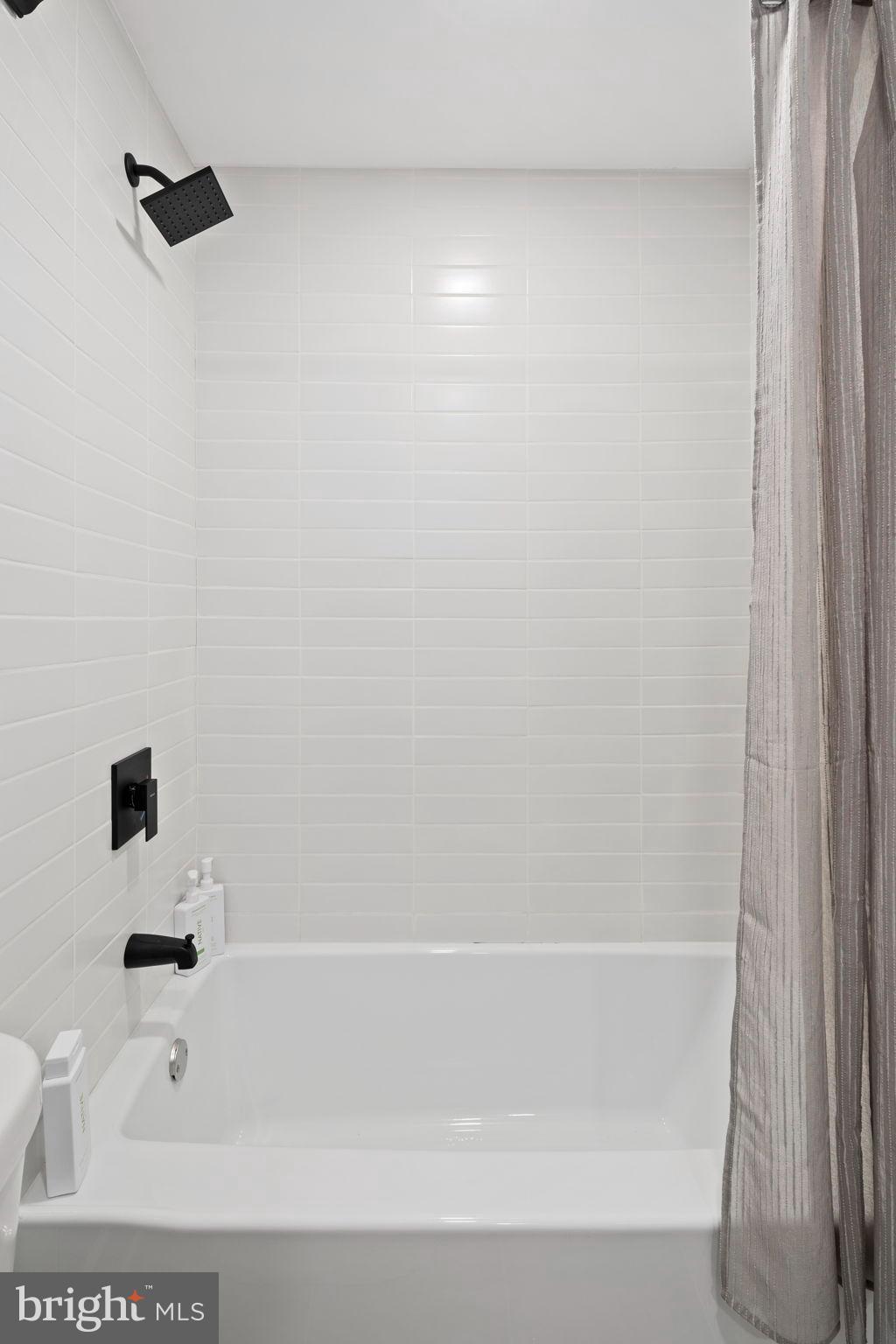 3418 Baker Street Northeast Washington, DC 20019 - Photo 23 of 46 a bathroom with a bathtub