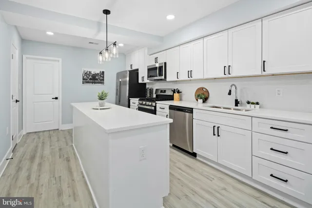 a kitchen with cabinets a sink and appliances