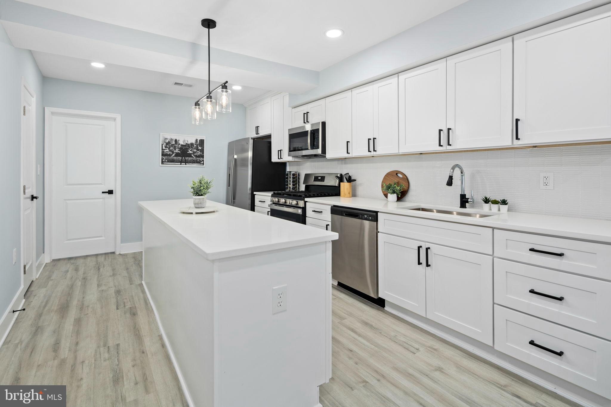 3418 Baker Street Northeast Washington, DC 20019 - Photo 29 of 46 a kitchen with cabinets a sink and appliances