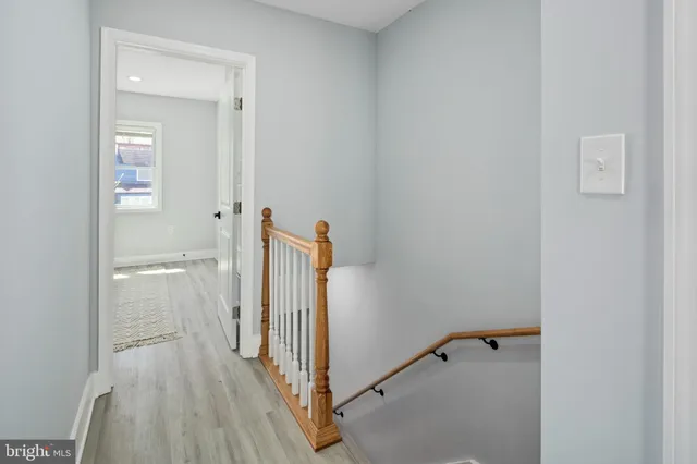 a view of a room with wooden floor and a bathroom
