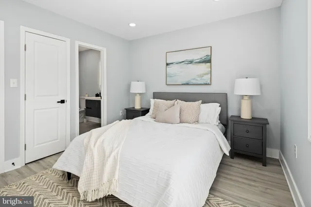 a bed room with a bed and a night stand