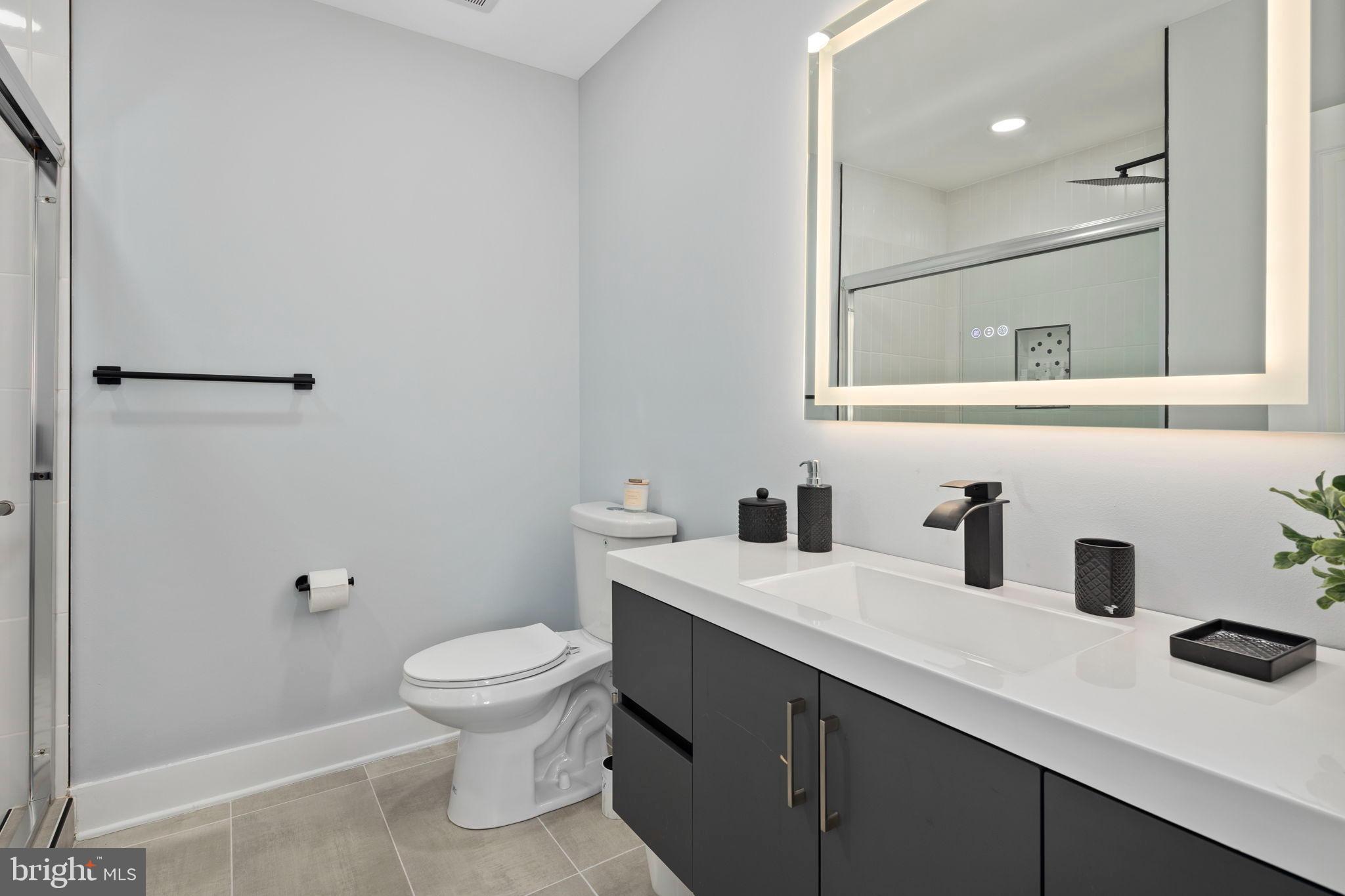 3418 Baker Street Northeast Washington, DC 20019 - Photo 36 of 46 a bathroom with a sink a toilet and shower