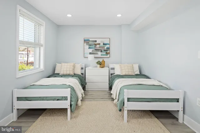 a bedroom with two beds and a window