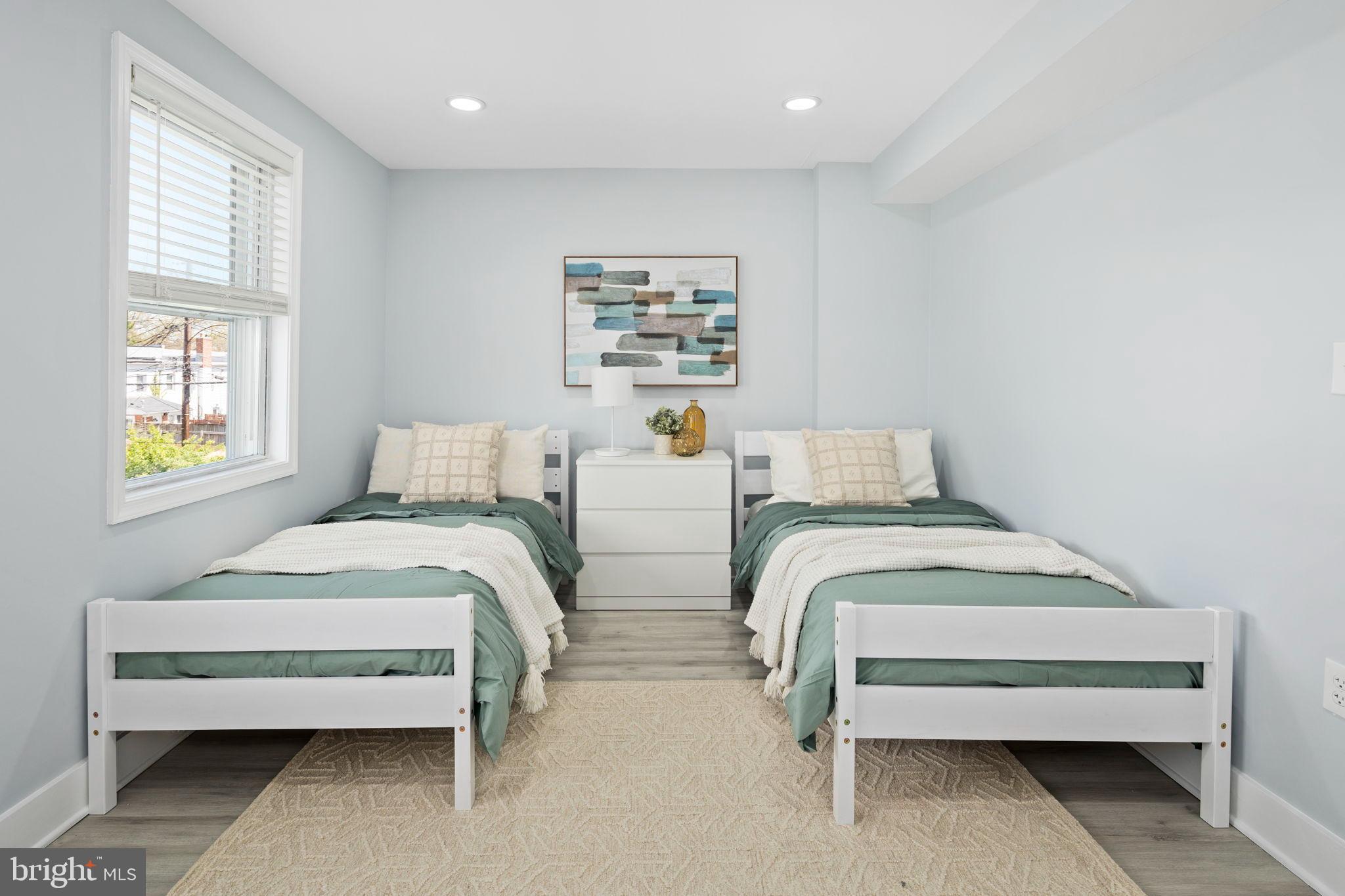 3418 Baker Street Northeast Washington, DC 20019 - Photo 38 of 46 a bedroom with two beds and a window