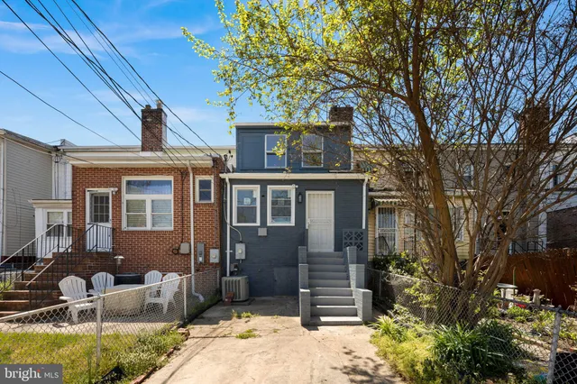 a front view of house with yard space and seating area