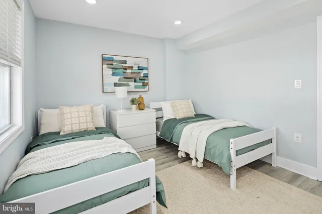 a bedroom with two beds and a couch