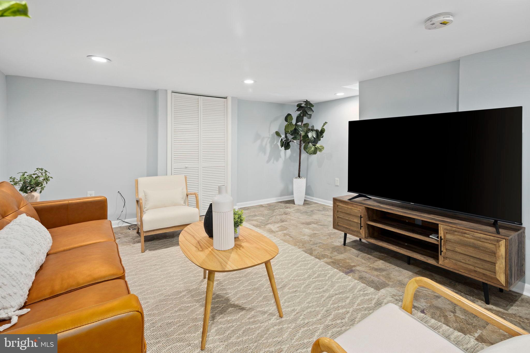 3418 Baker Street Northeast Washington, DC 20019 - Photo 7 of 46 a living room with furniture and a flat screen tv
