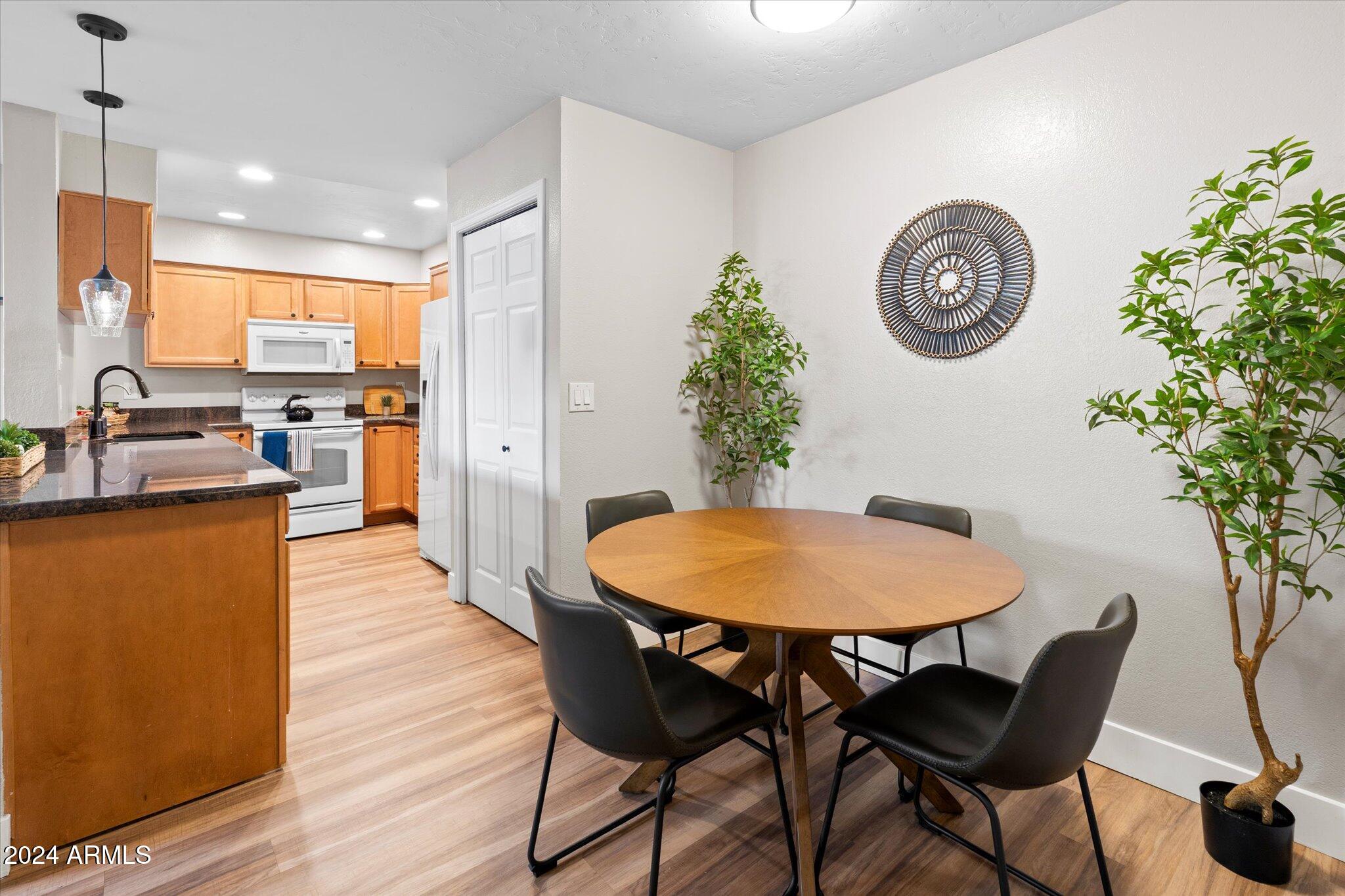 533 West Guadalupe Road, Unit 1063 Mesa, AZ 85210 - Photo 15 of 57 a dining room with furniture and a clock
