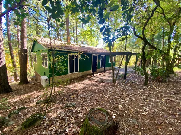 a view of house with a backyard