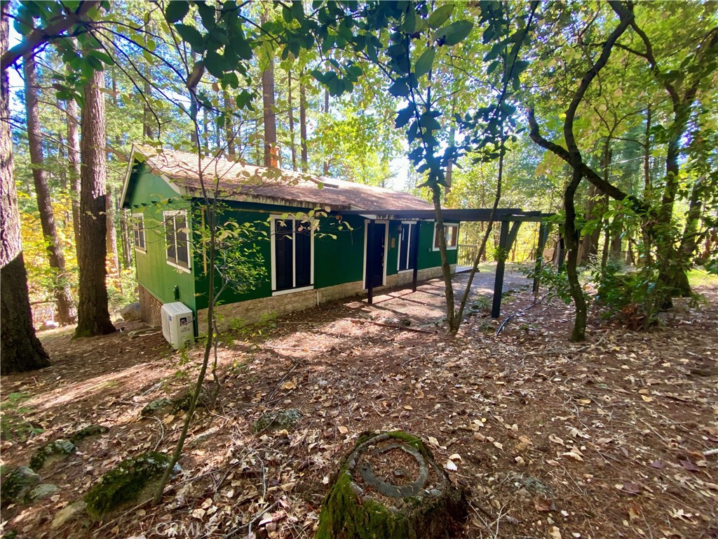 a view of house with a backyard