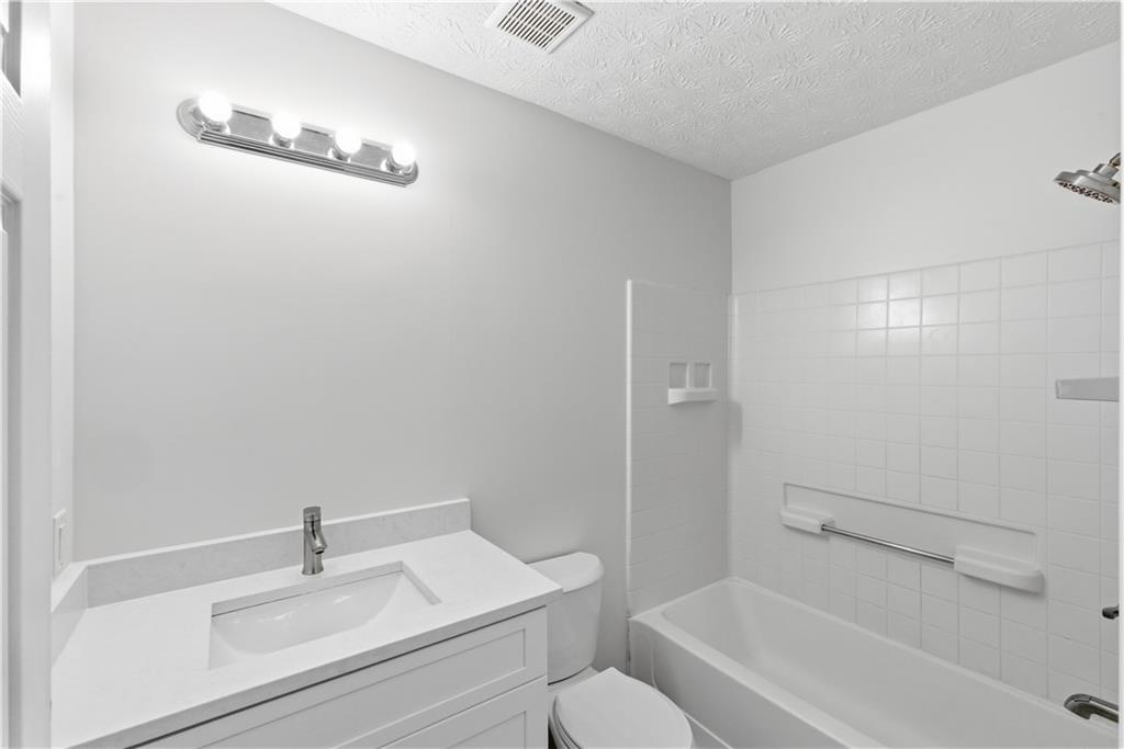 3789 Waldrop Lane Decatur, GA 30034 - Photo 12 of 22 a bathroom with a sink toilet and shower