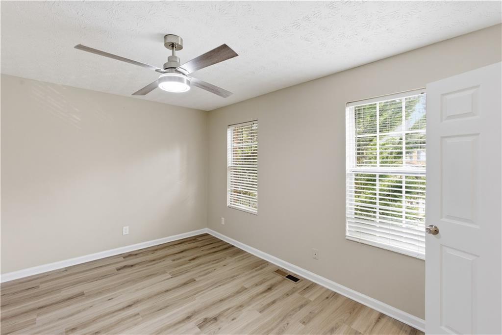 3789 Waldrop Lane Decatur, GA 30034 - Photo 16 of 22 a view of an empty room with wooden floor and a window