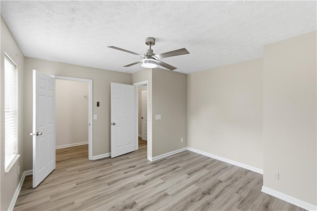 3789 Waldrop Lane Decatur, GA 30034 - Photo 17 of 22 an empty room with wooden floor and a ceiling fan