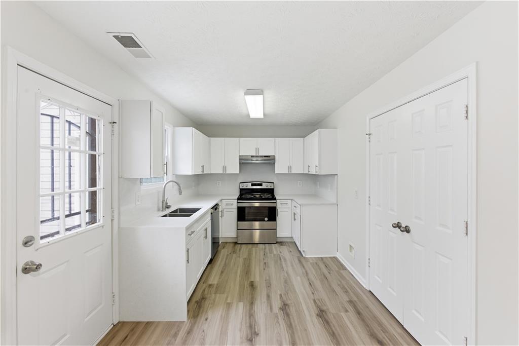 3789 Waldrop Lane Decatur, GA 30034 - Photo 6 of 22 a kitchen with white cabinets and appliances