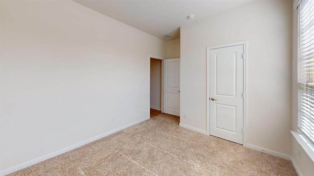 1306 Colonial Bluff Lane Princeton, TX 75407 - Photo 17 of 27 Neutral-toned walls complement the light brown carpet