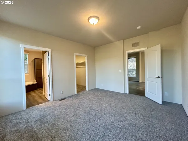 a view of an empty room and bathroom