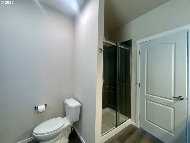 a bathroom with a toilet and a shower