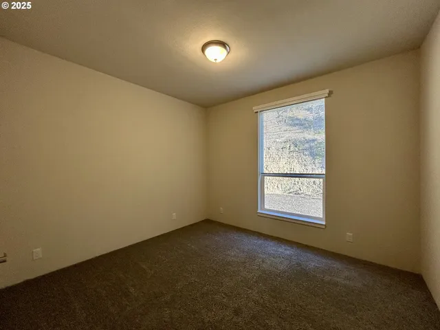 an empty room with a empty space and windows