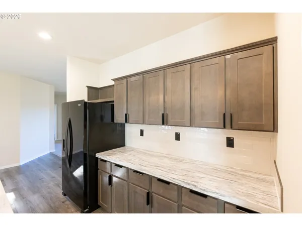 a kitchen with stainless steel appliances granite countertop a refrigerator and a sink