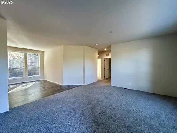 an empty room with windows and closet