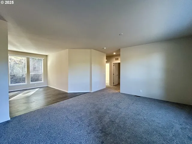 an empty room with windows and closet