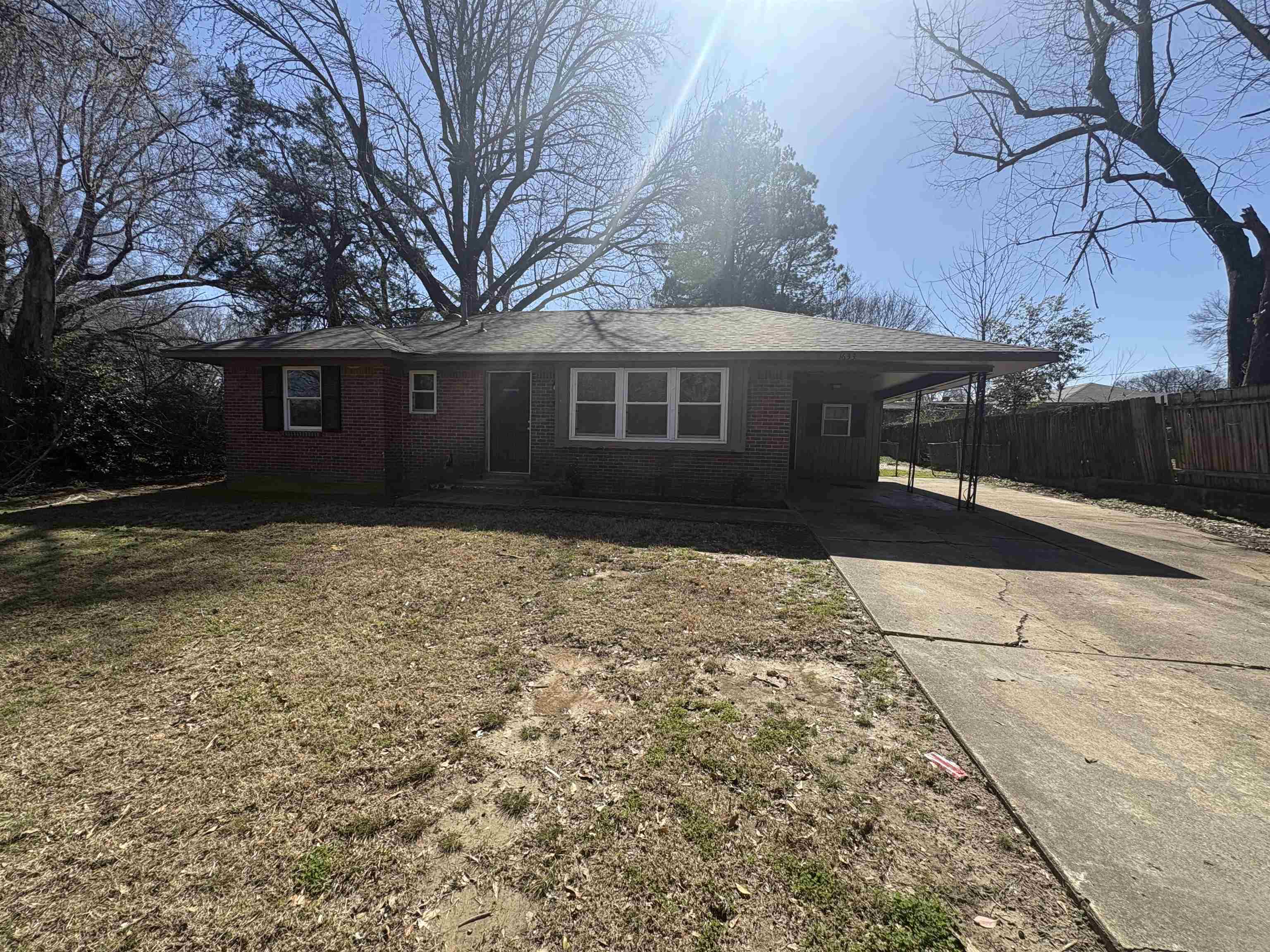 1633 Puryear Road Memphis, TN 38116 - Photo 1 of 5 Ranch-style home featuring a carport, driveway, brick siding, and a front yard