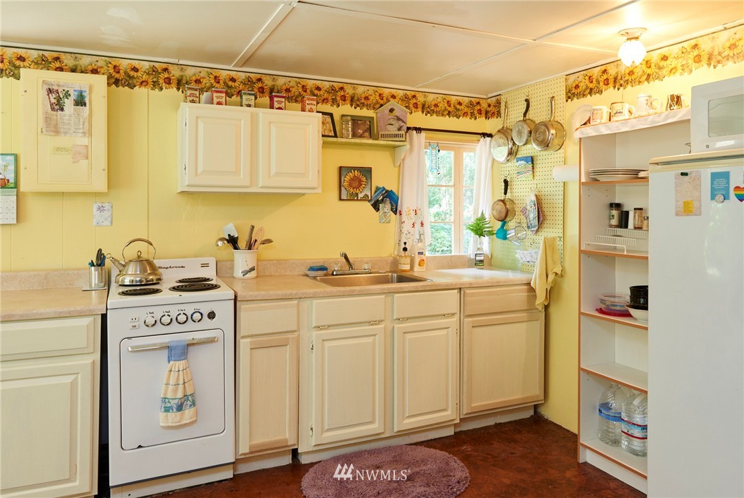 1505 East Roy Road Freeland, WA 98249 - Photo 7 of 13 a kitchen with stainless steel appliances a sink and cabinets