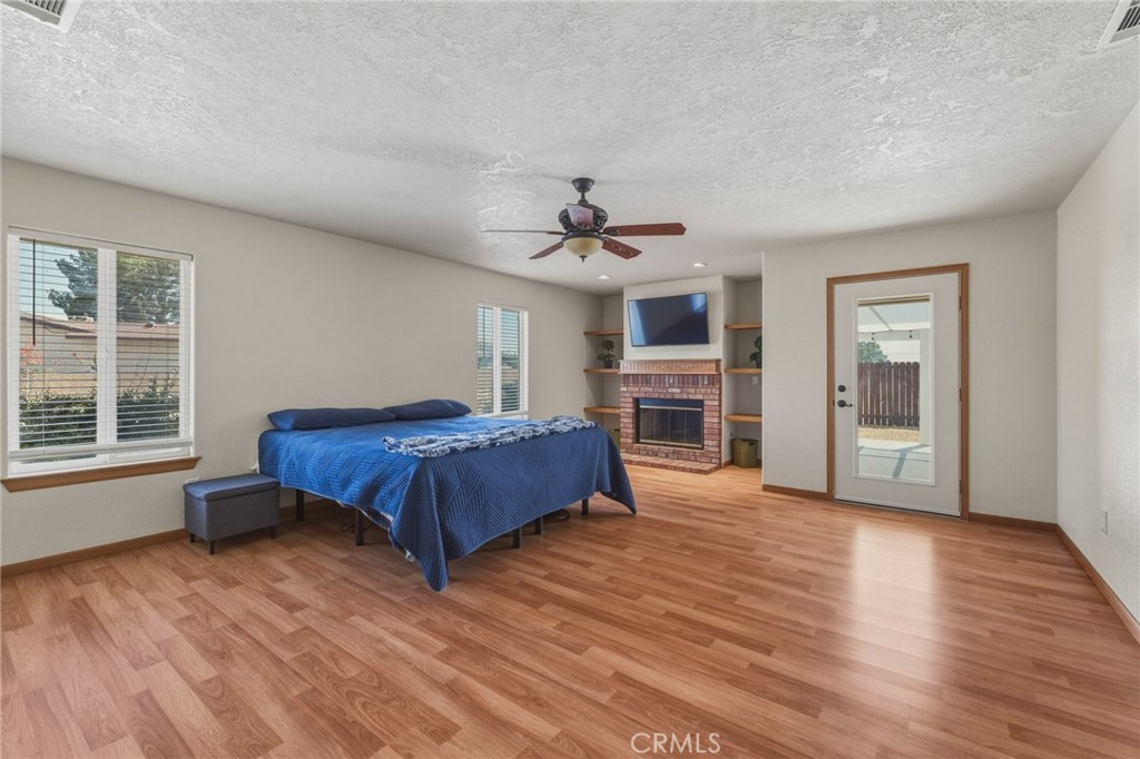 19501 Kinai Road Apple Valley, CA 92307 - Photo 26 of 49 a spacious bedroom with a bed dresser and a window