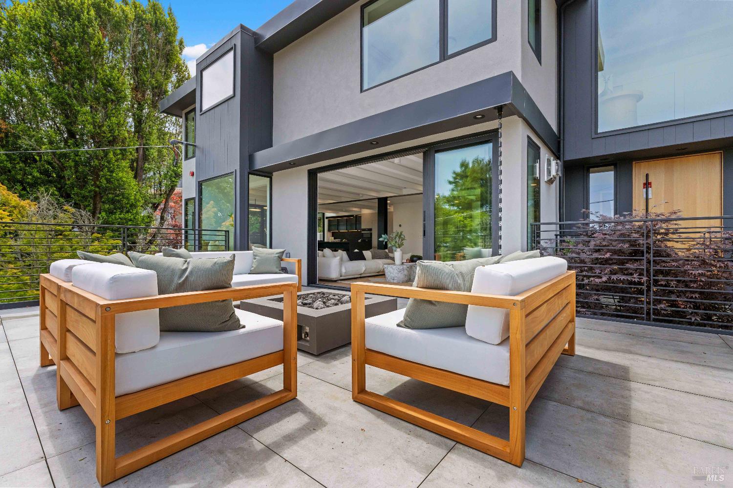 975 Greenhill Road Mill Valley, CA 94941 - Photo 5 of 53 a view of a patio with couches table and chairs with wooden floor and fence