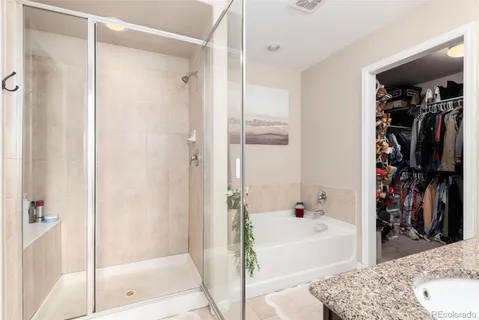 a bathroom with a tub shower vanity and a sink