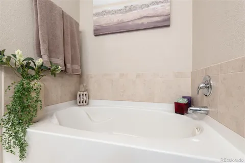 a white bath tub sitting next to a shower