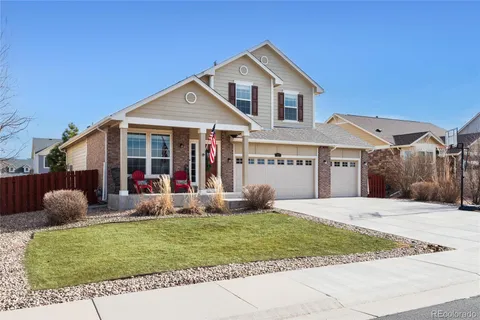 a front view of a house with garden and porch