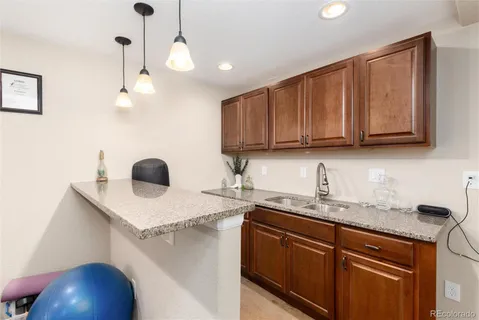 a kitchen with a sink a microwave and cabinets