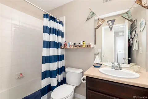 a bathroom with a sink a toilet a shower and a mirror