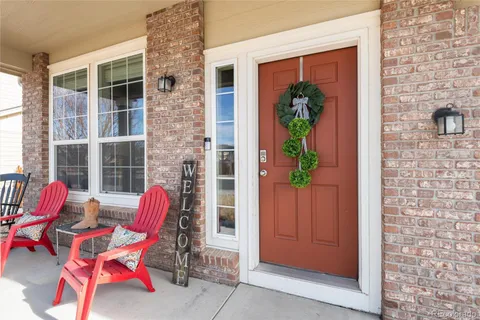 a view of a room with furniture and front door