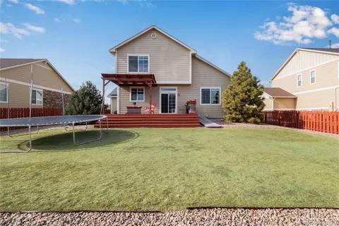 a view of a house with pool and chairs