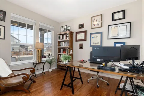 a view of a workspace with furniture and a window