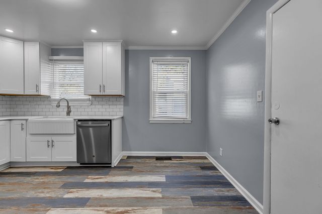 a view of a kitchen with a sink cabinets and a window