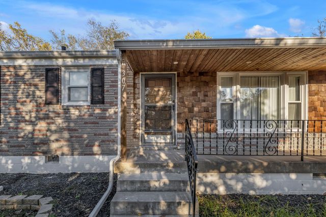 a view of a brick house with a large window