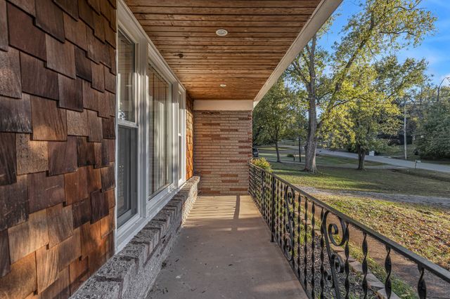 a view of a porch with wooden floor and fence