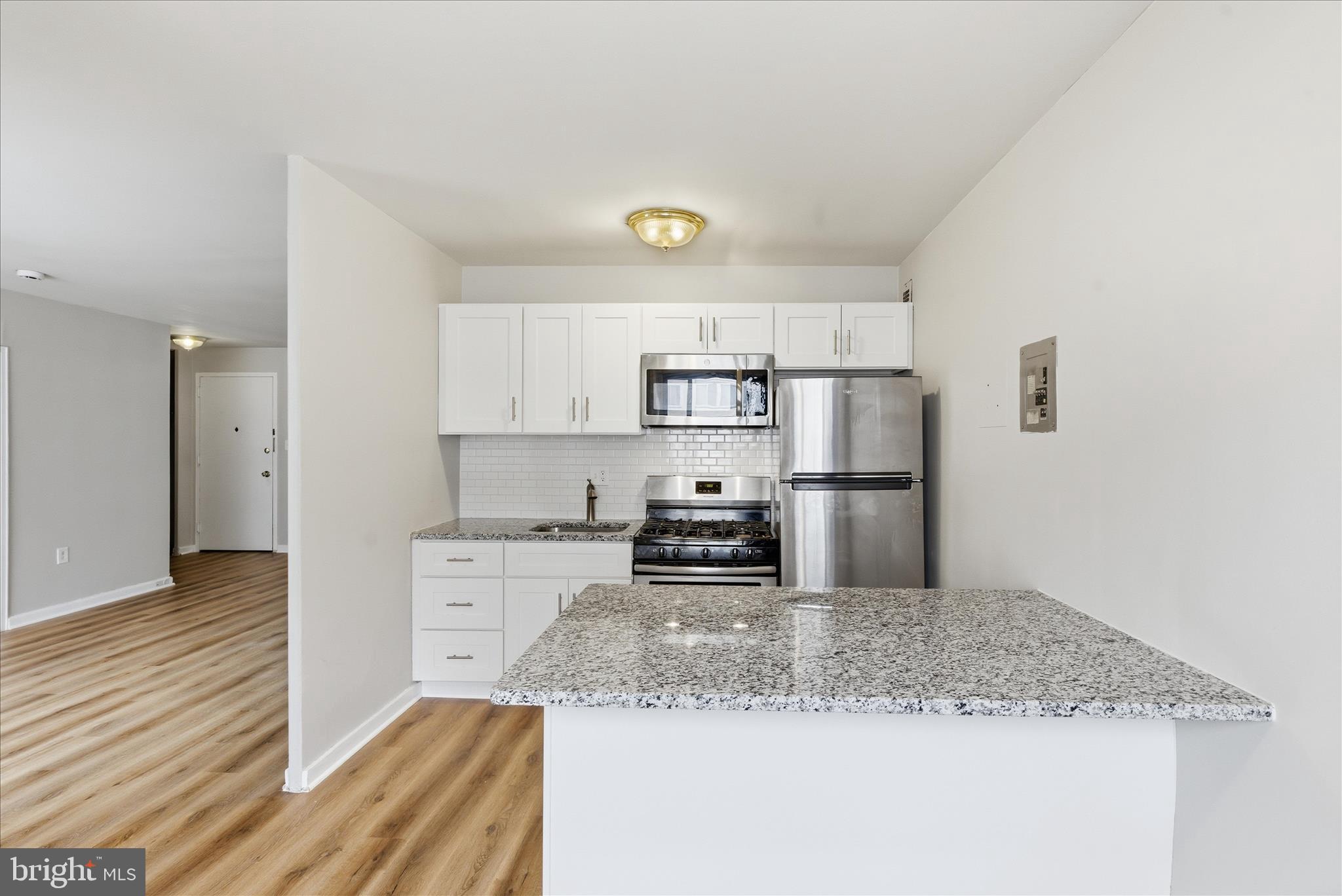 1200 South Arlington Ridge Road, Unit 717 Arlington, VA 22202 - Photo 1 of 24 a kitchen with stainless steel appliances granite countertop a sink refrigerator and cabinets