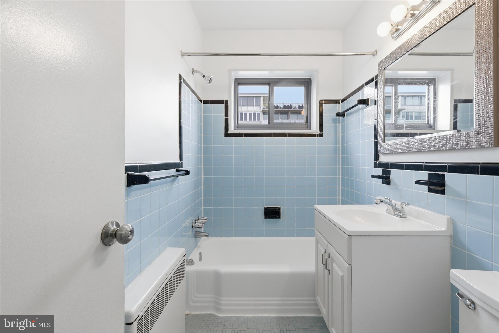 1200 South Arlington Ridge Road, Unit 717 Arlington, VA 22202 - Photo 12 of 24 a bathroom with a sink a toilet and shower
