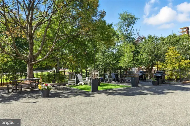 a swimming pool with outdoor seating and trees