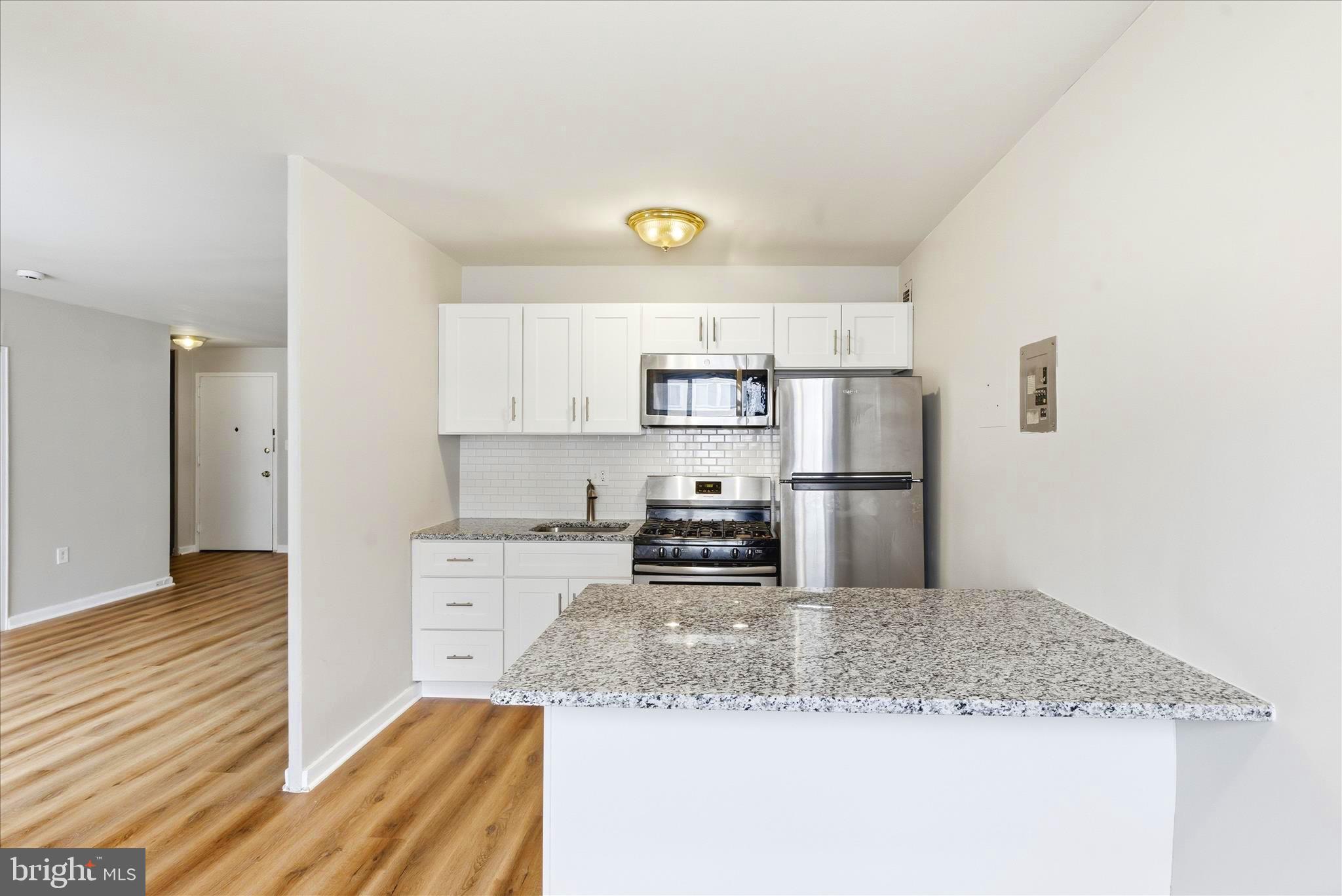1200 South Arlington Ridge Road, Unit 717 Arlington, VA 22202 - Photo 3 of 24 a kitchen with a refrigerator sink and cabinets